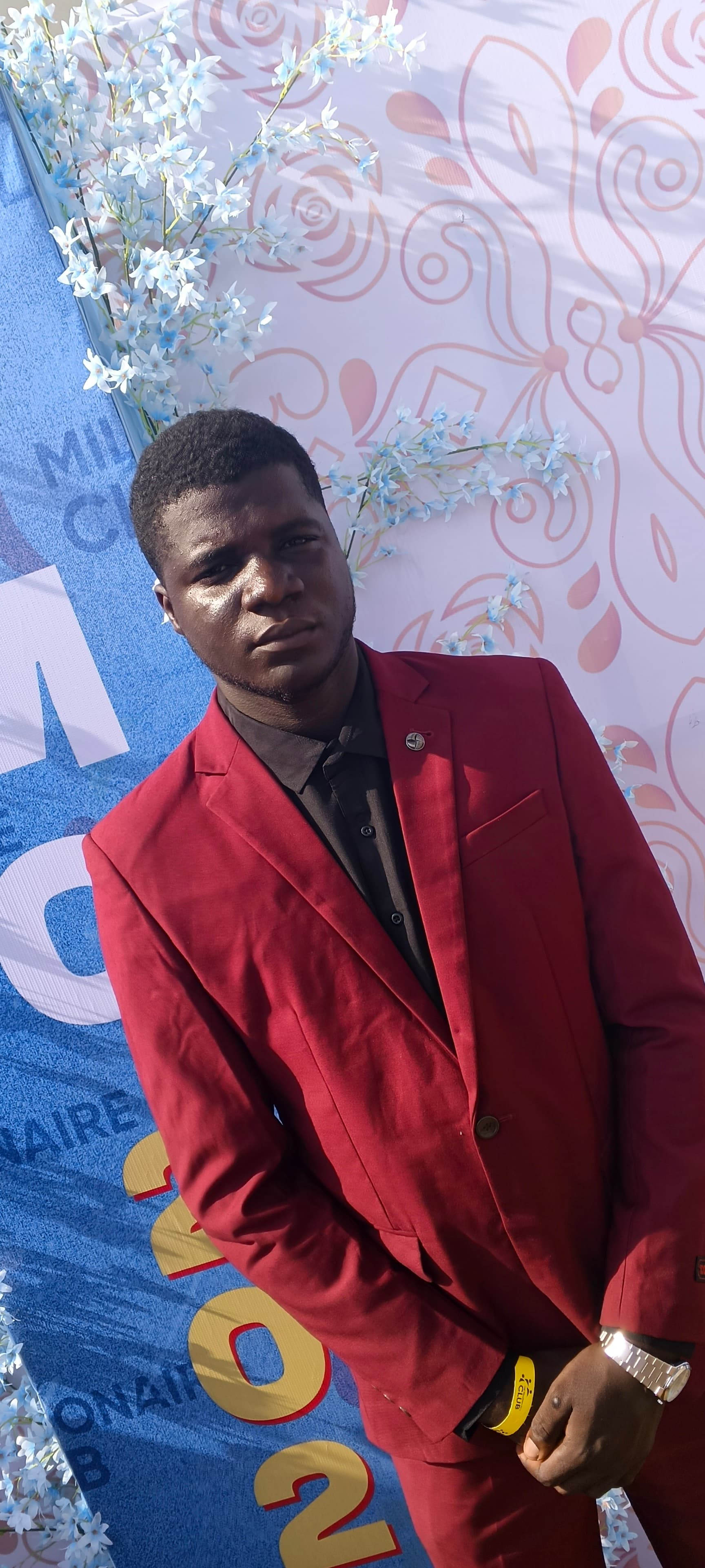 AGNIX TMC Event 2025 - Participant in Red Suit at TMC 2025